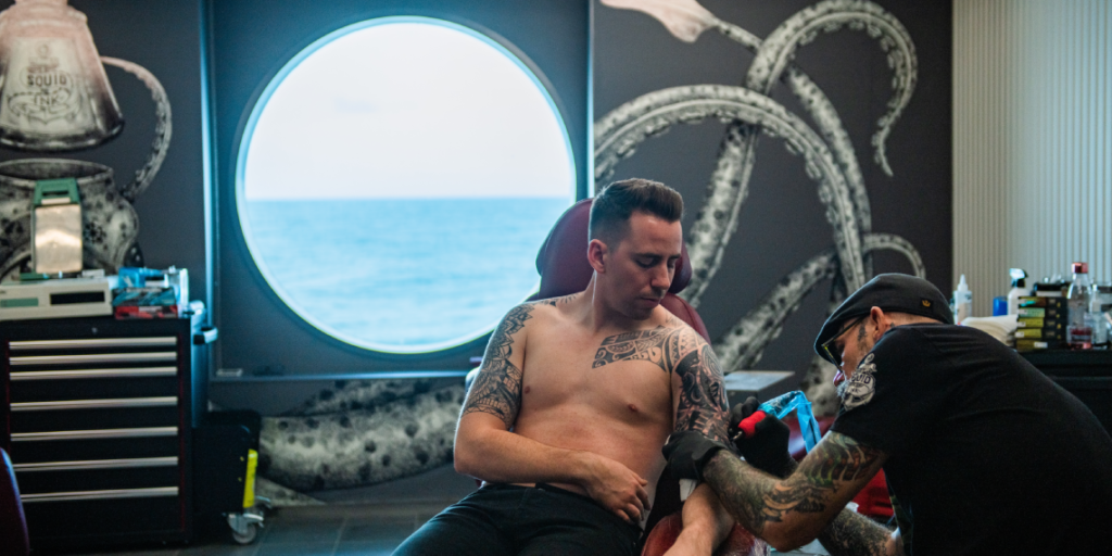 Someone getting tattooed by guest tattoo artist Jason Ackerman at Squid Ink.