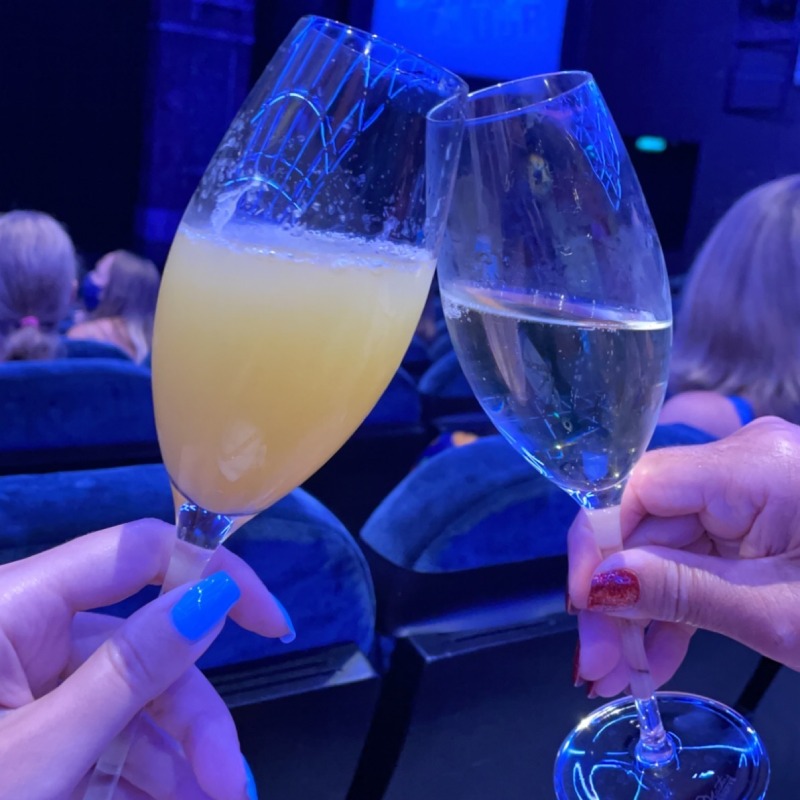 Champagne glasses clinking in the Norwegian Getaway theatre