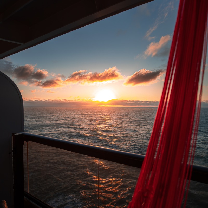 Sunset as seen from a Sea Terrace cabin on Scarlet Lady